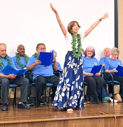  Kathleen Schafer, 57, of Novi, dances as other members of Novi’s senior chorus sing “Moonlight in Hilo,” during a performance at Rolling Hills Retirement Community Sept. 11. The theme of the performance was a musical journey around the world. 