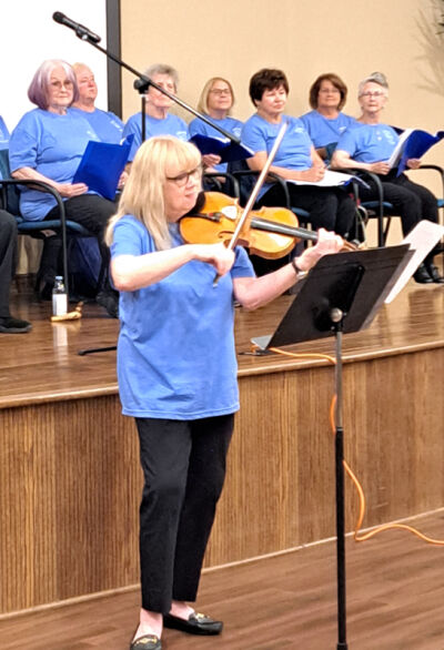  Sue Pinto, 71, a former music instructor for children with cognitive disabilities, performs a violin solo during a Beyond Belief performance of the Beatles hit “Yesterday.” 