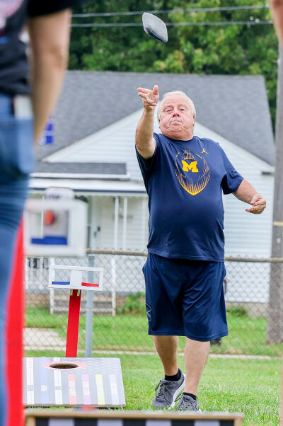  Richard “Pops” Socha, known for being a good player, takes a shot during the cornhole competition.  