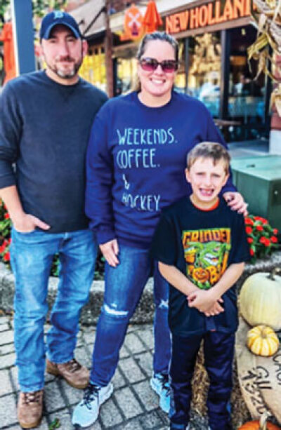  Warren police officer Nick Kott, left, is shown with his wife and son. Kott was injured in a fall while hunting in November 2024. 