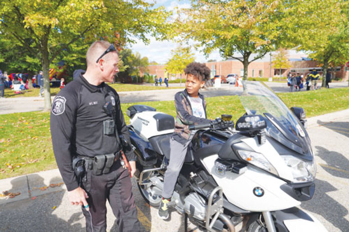  A young girl interacts with a police motorcycle at last year’s Citywide Open House in Farmington Hills. 