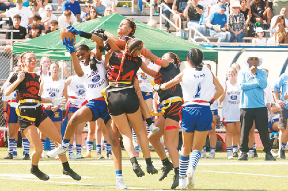  Regina players jump to make a play on the ball against Marian. 