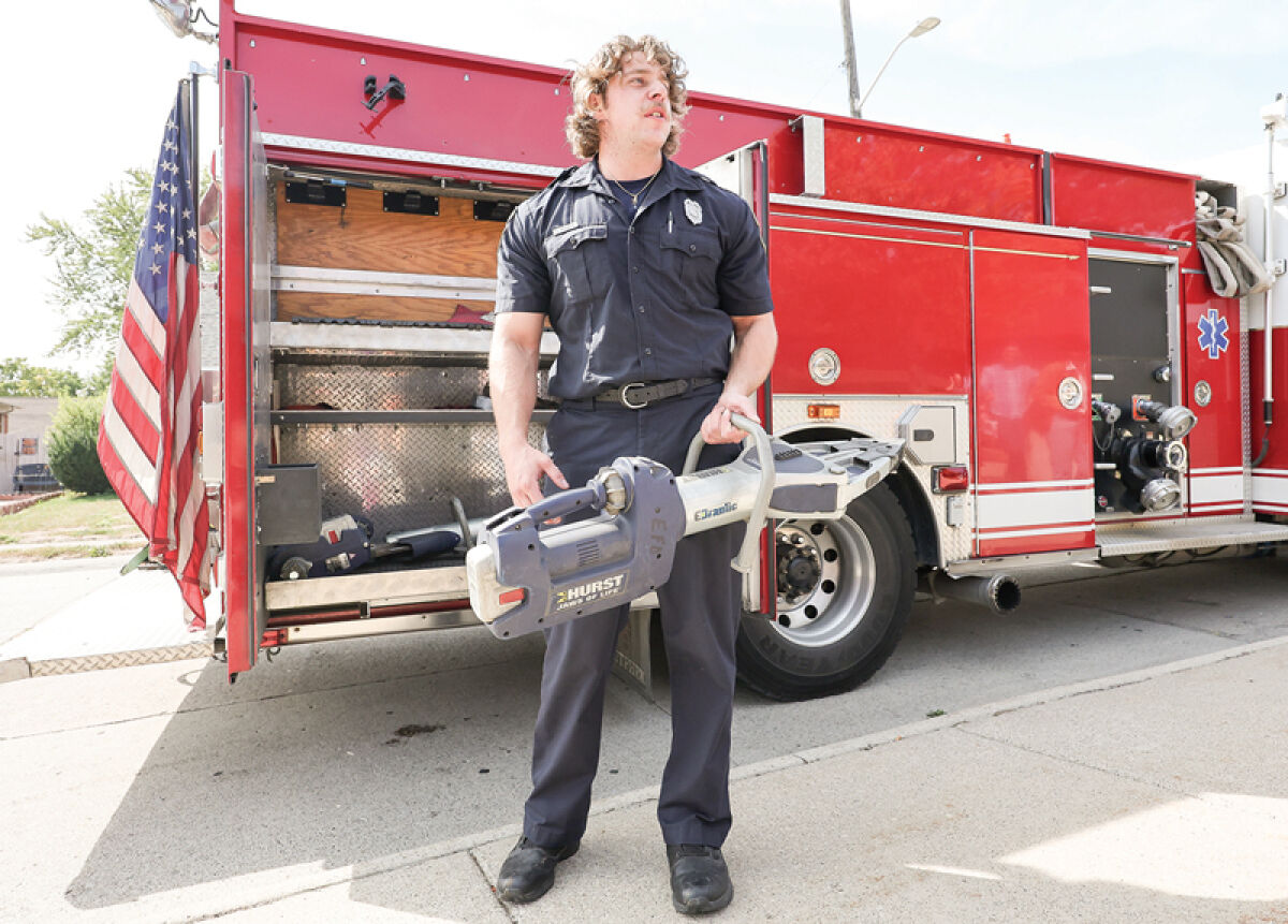  Eastpointe firefighter Dominic Rossetti talks to residents about the equipment on the fire truck, including the Jaws of Life during a fire safety workshop at the Eastpointe Memorial Library Sept. 20. 