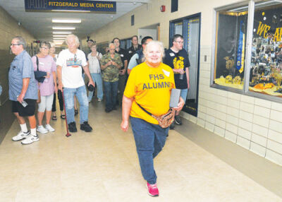   Barb Willis, class of 1979, takes the leads with  fellow alumni as they take a tour inside Fitzgerald High  School Sept. 19. 