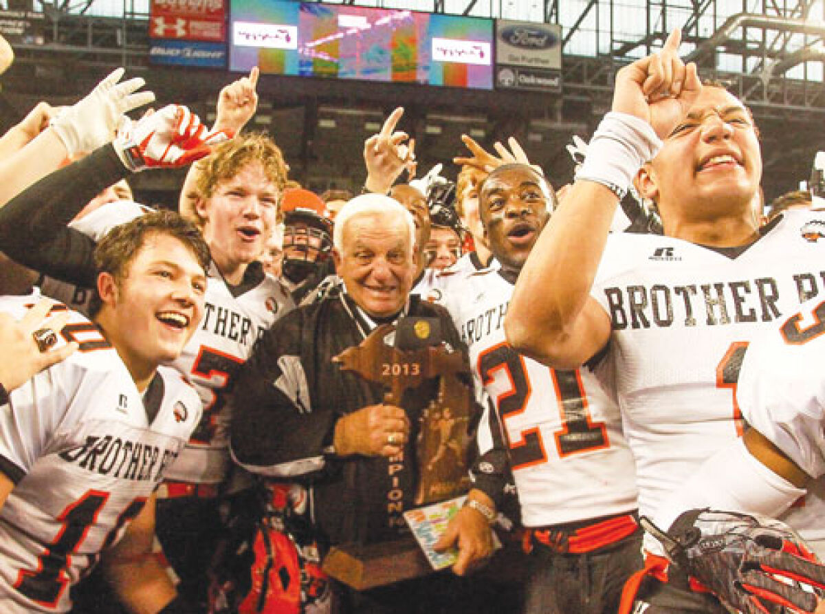  Al Fracassa celebrates with his players after winning the 2013 state championship game at Ford Field. It was the last game he’d ever coach. 