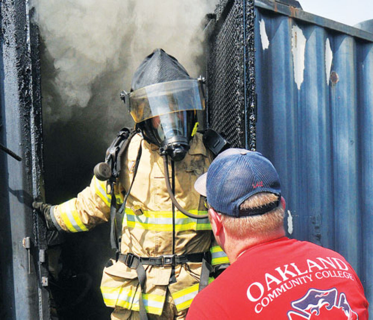  A firefighter emerges from the flashover simulator as firefighters from the Farms and other communities take part in flashover training Sept. 18. 