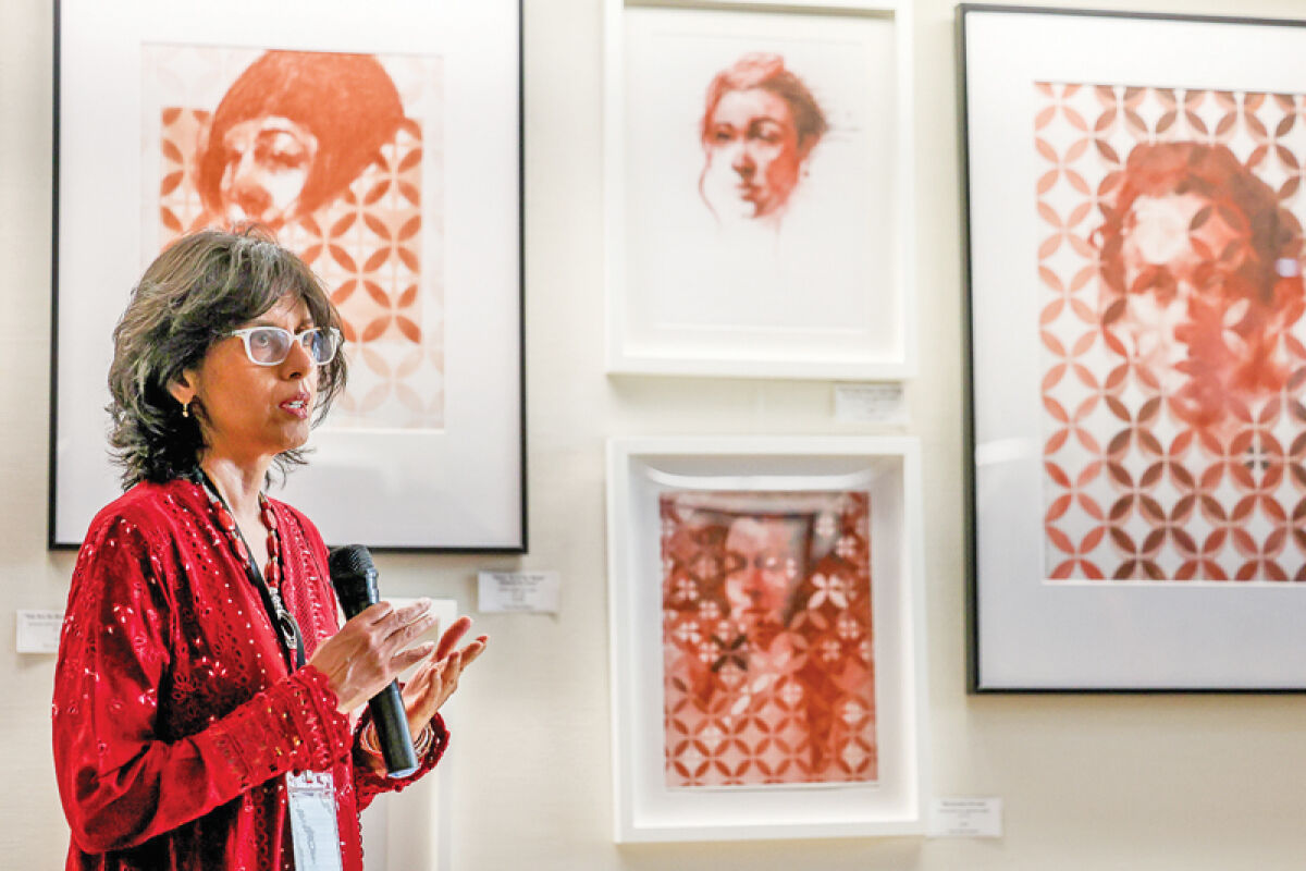  Artist Nina Ashraf speaks about her work at the opening reception of the city’s art exhibition at City Hall. 