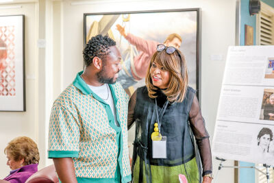  Southfield Public Arts Commission Chairperson Delores Flagg meets with artist Jonathan Kimble, who has two pieces of art in the exhibition. 