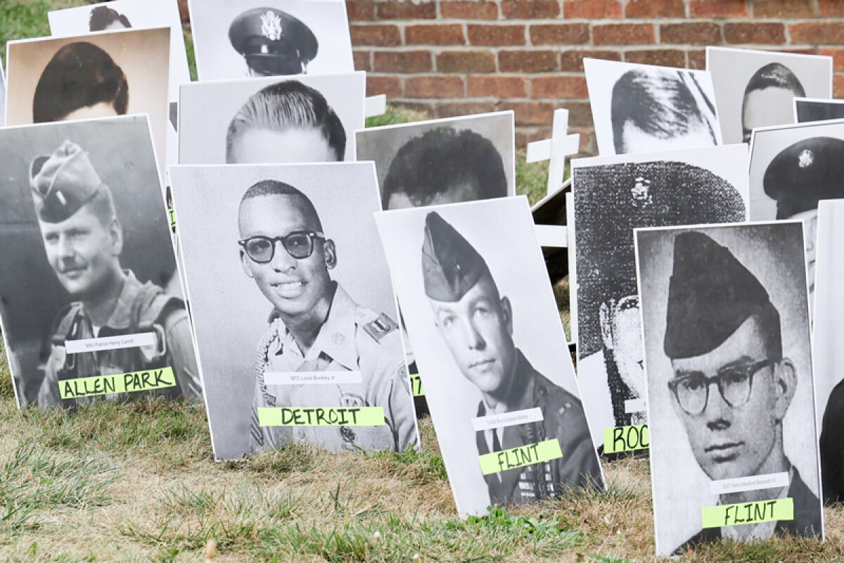 Pictures of Michigan’s POW/MIAs with the cities that they were from are placed on white wooden crosses and fill the lawn in front of the memorial at Oakland Memorial Gardens in Novi Sept. 19. 