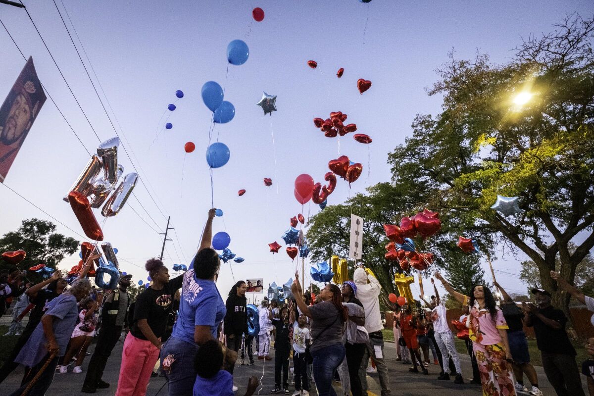 Friends and family members of Cedric Hayden Jr. and DeJuan Pettis release balloons during a vigil held in Warren on the one-year anniversary of the crash that killed them.  