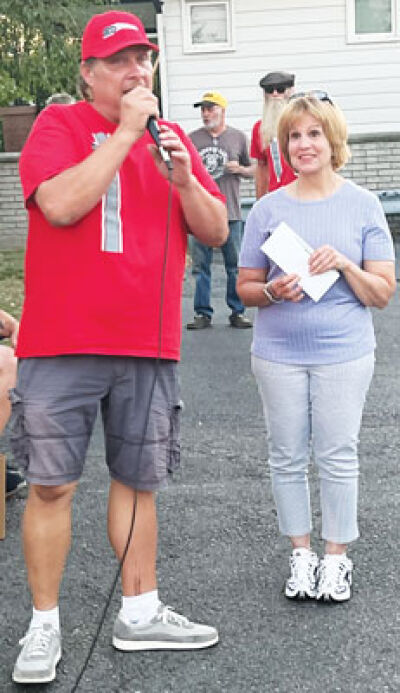  At the Sept. 17 Sandbaggers car show in Center Line, Warren resident Paul “Pauly G” Gutkowski, left, presented Cindy Yankley, events director for the I Heart Dogs Rescue & Animal Haven, right, with a $1,832 check for the animal shelter. The money was raised during the Center Line Beer Fest at the city’s Memorial Park Sept. 13. 
