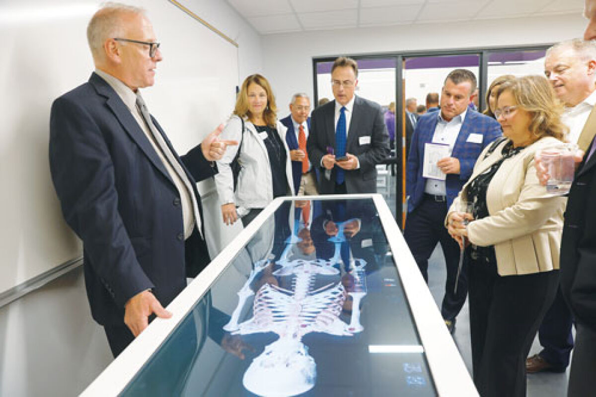  Jeffrey Sweet, senior regional sales representative for the Ohio Valley Region at Anatomage, left, demonstrates how the Anatomage Table works. 