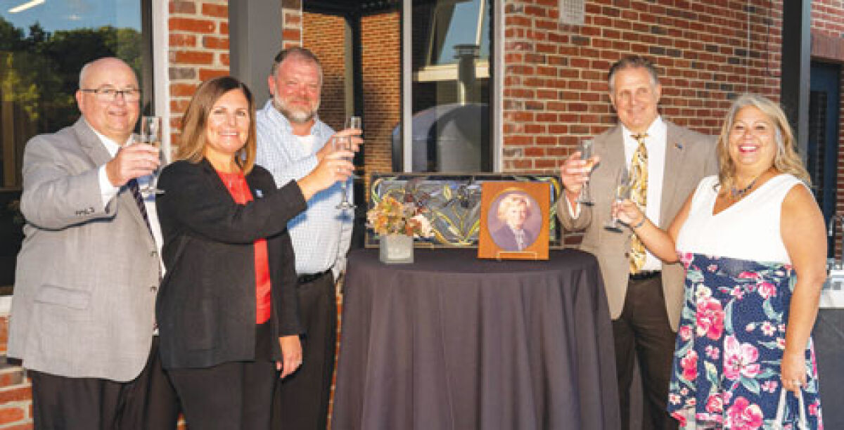  Pictured from left to right, Macomb Community College President James O. Sawyer IV; Libby Argiri, the college’s executive vice president of administration; Brian Newman, an accounting professor; Mike Balsamo, dean of business, information technology and culinary; and Monique Beauchamp, a marketing professor drink a toast in honor of longtime MCC accounting professor Shirley Glass, after whom the school’s new outdoor terrace is named. 