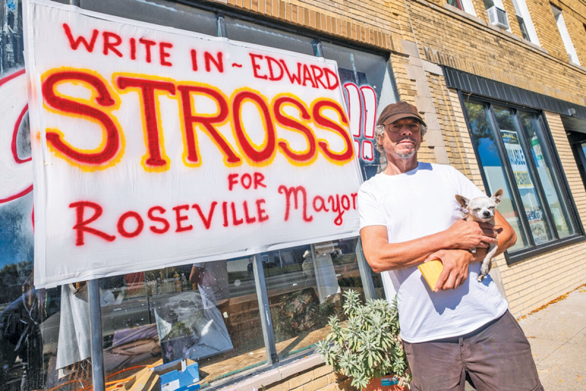  Artist and advocate Edward Stross poses for a portrait near a sign he painted outside his art studio on Gratiot Avenue Wednesday, Oct. 1, in Roseville. 