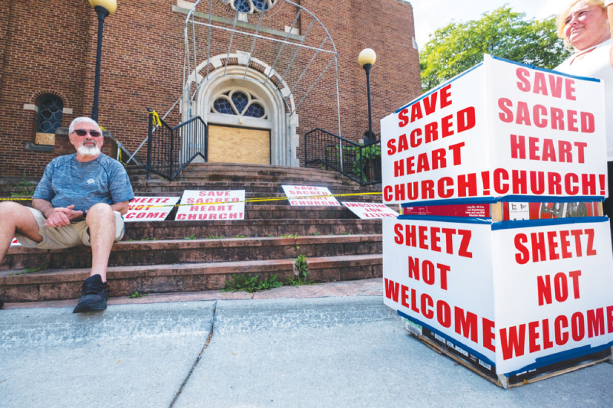  People gather Saturday, Aug. 16, for a press conference regarding a lawsuit filed in an attempt to save the former Catholic Community of  Sacred Heart church in Roseville. 