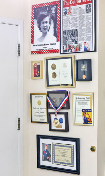  Mementos and tributes are displayed on the wall. 