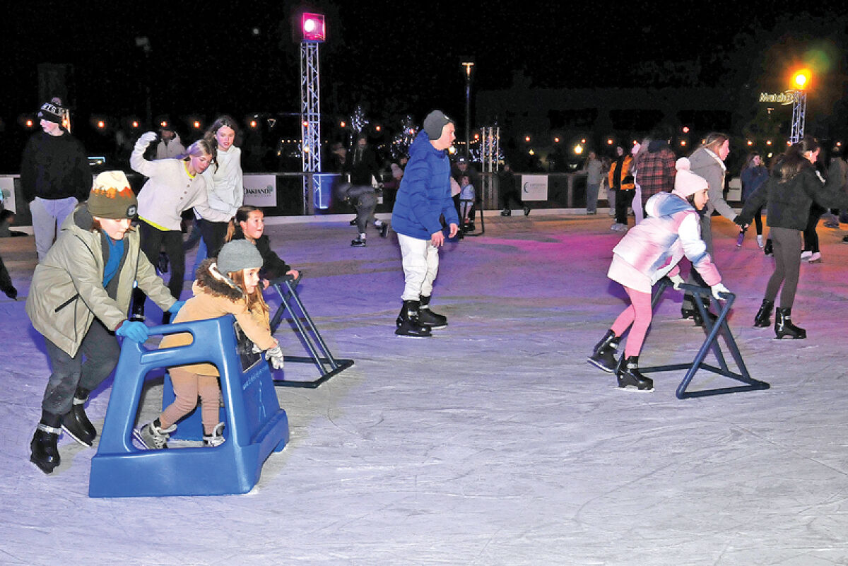 People glide over the ice on the rink in downtown Royal Oak during last year’s Royal Oak Holidays. Royal Oak Holidays and the Winter Blast are merging into one event starting next month. 