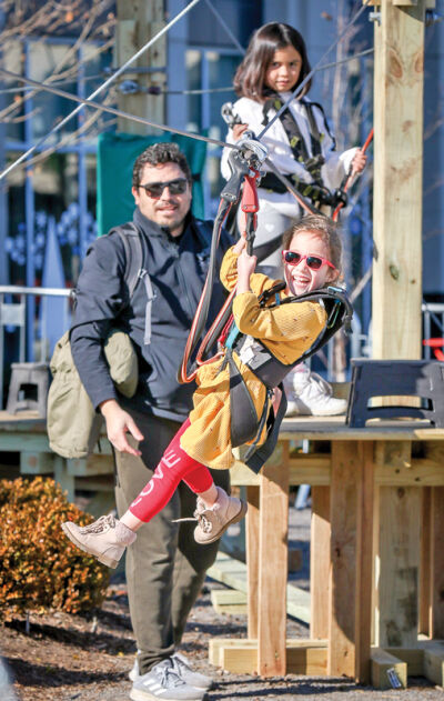  Ivana Puebla, 5, of Sterling Heights, rides a zip line during the Winter Blast in 2024. Winter Blast has now merged with Royal Oak Holidays. 