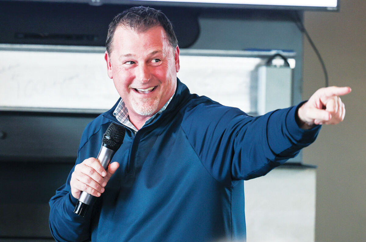  Klint Pleasant points at the crowd of spectators as he is honored for being inducted into the Basketball Coaches Association of Michigan Hall of Fame. 