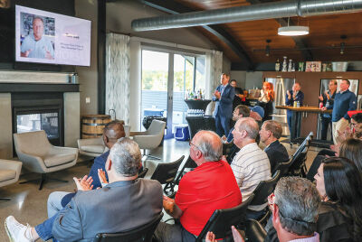  The spectators on hand watch the message from Michigan State University’s Tom Izzo congratulating Pleasant on his accomplishment. 