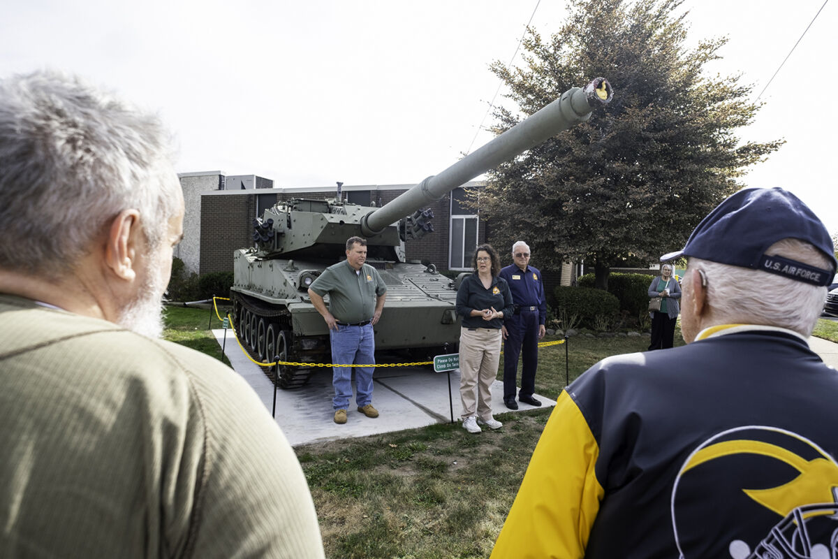  Spectators watch as representatives from the Michigan Military Technical and Historical Society hold a dedication ceremony for the museum’s new M8 tank Friday, Oct. 17, in Eastpointe. 