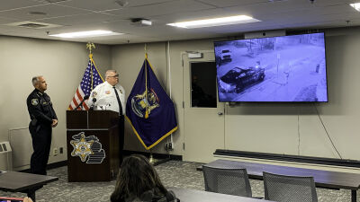  At an Oct. 23 press conference at the Macomb County Jail training room in Mount Clemens, Macomb County Sheriff Anthony Wickersham, left, and Roseville Police Chief Mitchell Berlin watch as security camera footage is shown from an incident that led to an officer-involved shooting earlier this month. 
