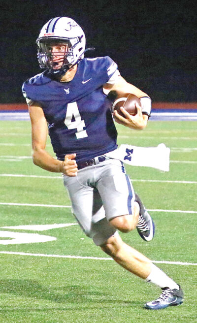  Farmington quarterback Vincent Pesci runs in a game against Troy on Oct. 3 of this season. 