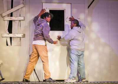  Two survivors secure the farmhouse door. From left, senior Kayden Morton-Tellis, plays Ben, while junior Timothy Hawk plays Harry. 
