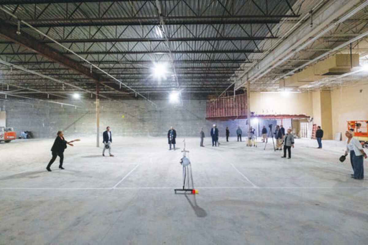  Sterling Heights city officials play a game of pickleball on a makeshift court inside the property that will be renovated to become the city’s new pickleball facility Oct. 23. 