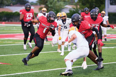  Roseville junior Huston Eubank runs the ball against Dearborn Heights Crestwood on Aug. 25. 