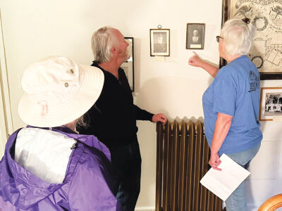  Guests admire the original photos within the Orson Starr House. 