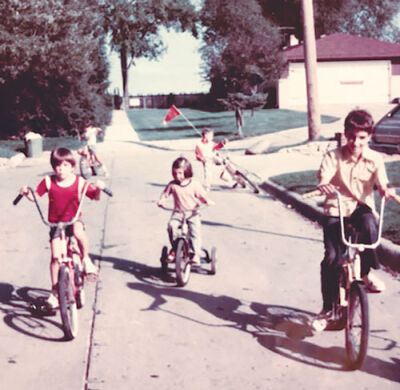  Children ride their bikes in this undated historical photograph from Eagle Pointe on the Lake. 