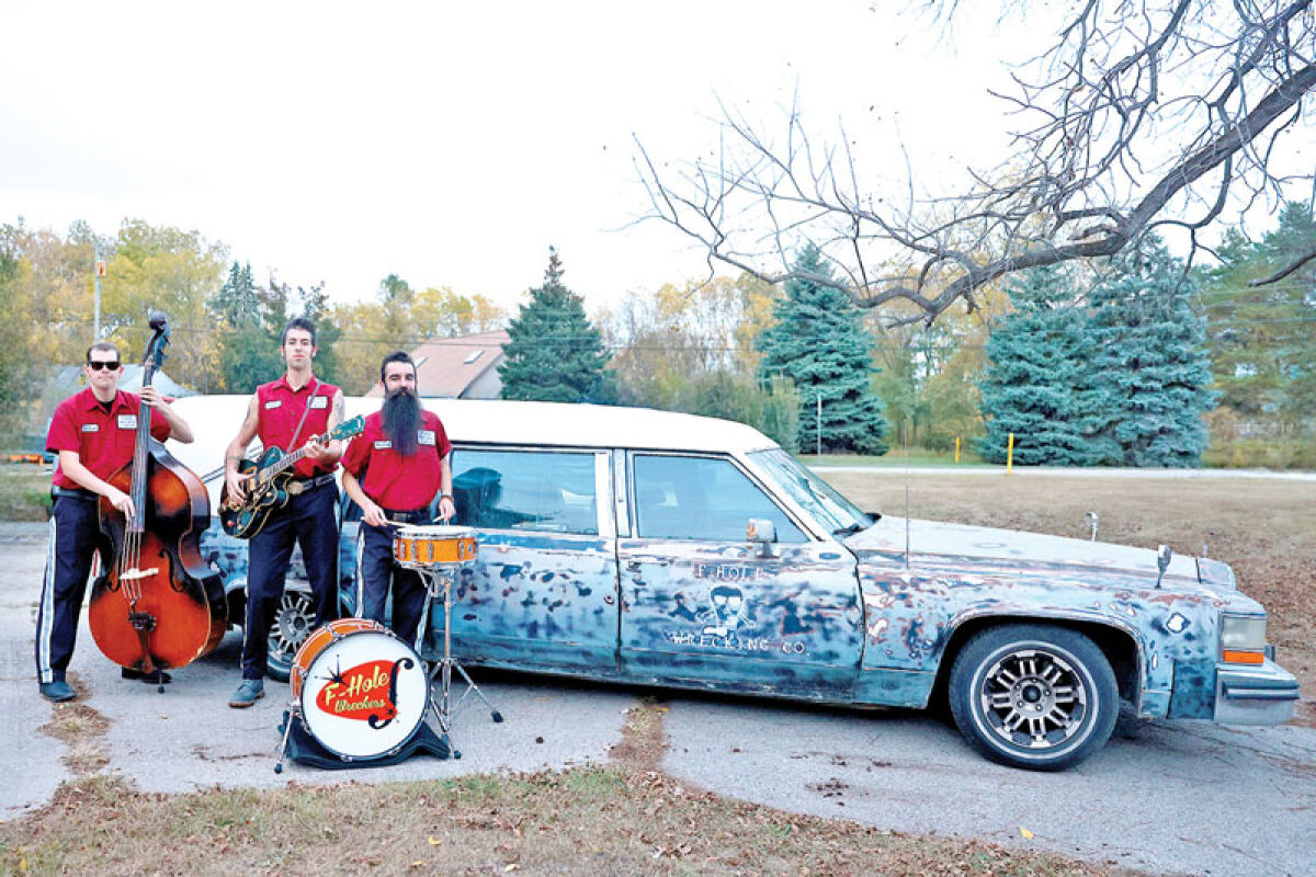  The F-Hole Wreckers, from left, Adam Bob, Kurt J. and Bradley James, travel to gigs in a 1984 Cadillac DeVille limousine hearse. 