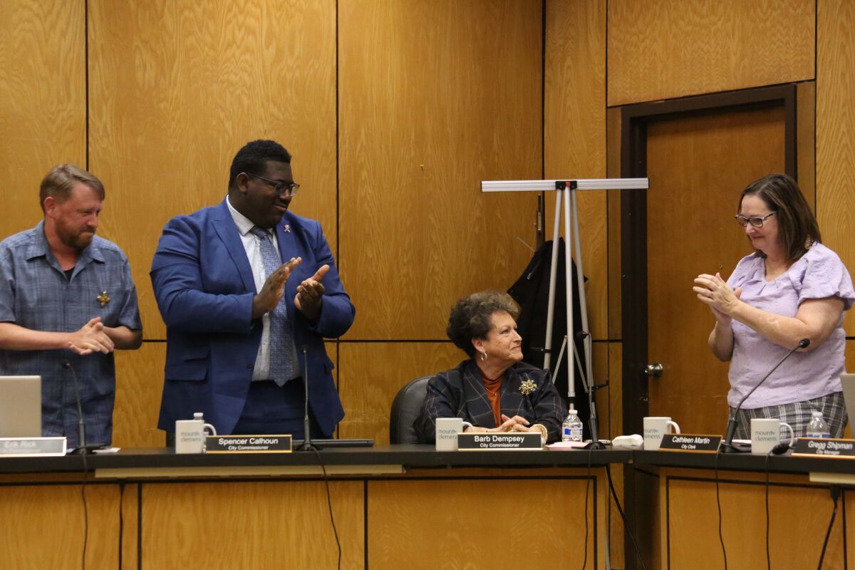  Mount Clemens Commissioners Erik Rick, left, Spencer Calhoun and Clerk Cathleen Martin clap for outgoing Commissioner Barb Dempsey at the Nov. 3 Mount Clemens City Commission meeting. 