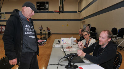  Royal Oak poll workers assist a voter at Royal Oak High School during the Nov. 4 general election.  
