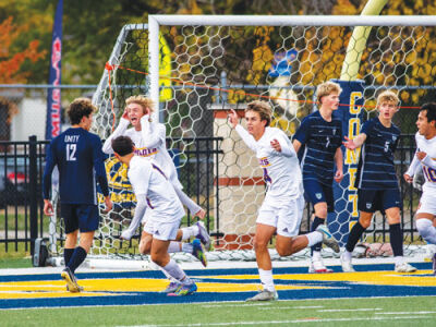  Senior James Spicuzzi scores and puts his hands to his ears to celebrate the first goal of the game with his teammates. The final score was 2-0. 