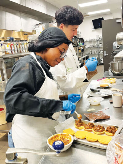  Roseville High School junior Kendall Smith, front, and senior Logen Kaid prepared beef stew sliders, peanut butter poundcake, garlic breadsticks, coffee and Kool-Aid. 