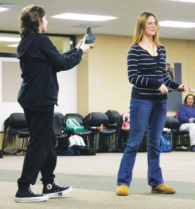  Jack (sophomore Sarah Murphy, left) shows off a goose stolen from giants to Little Red Riding Hood (senior Sam Hoch), who challenges Jack to steal more from the giants. 