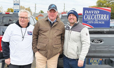  At right, Grosse Pointe City Council candidate-elect David A. Calcaterra campaigns Nov. 4 outside the Neighborhood Club with, from left, his dad, David M. Calcaterra, and mayoral candidate Christopher Boettcher.  