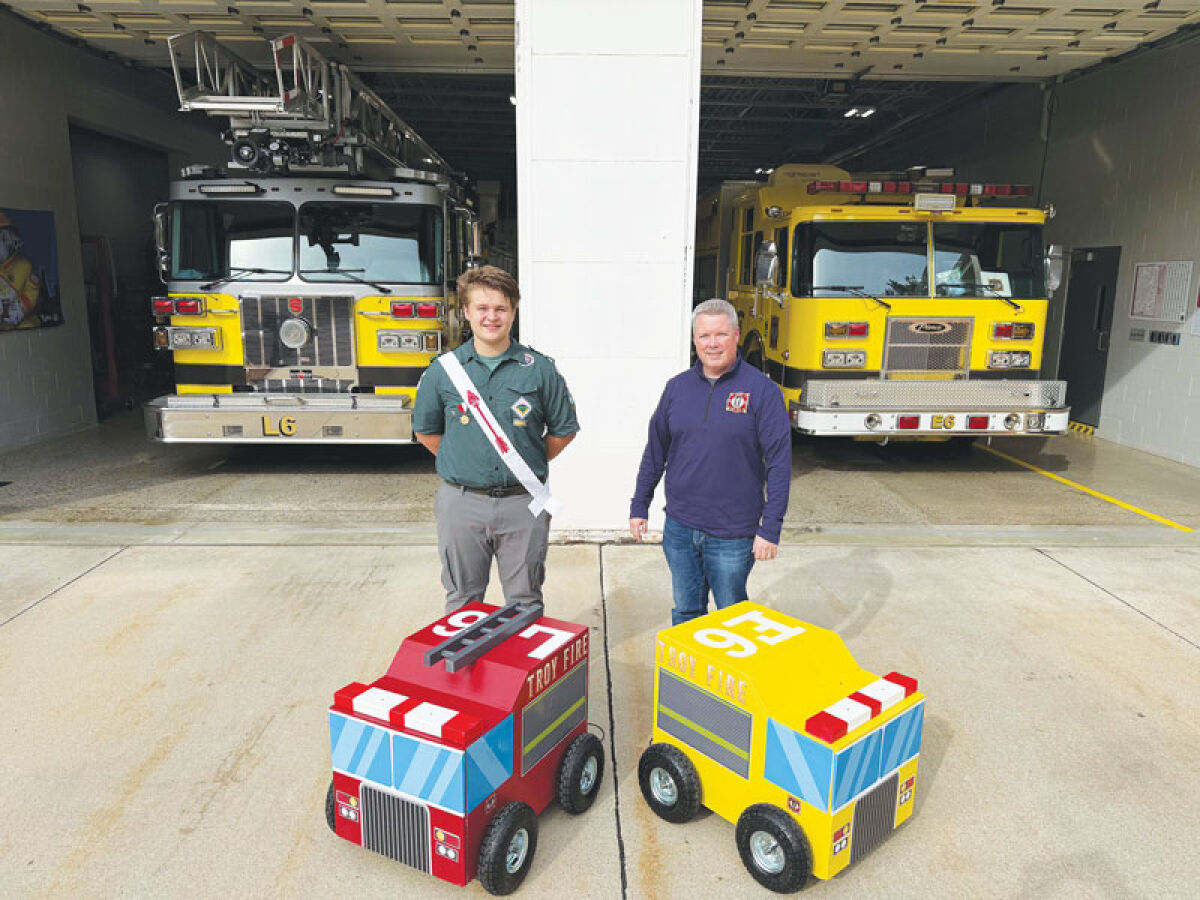  Lucas Rossi and Troy Fire Chief Peter Hullinger survey the new “flow trucks” Rossi created as a part of his Eagle Scout project. 