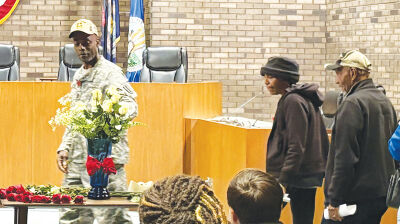  Veterans place roses in a vase dedicated to a veteran of their choosing. 