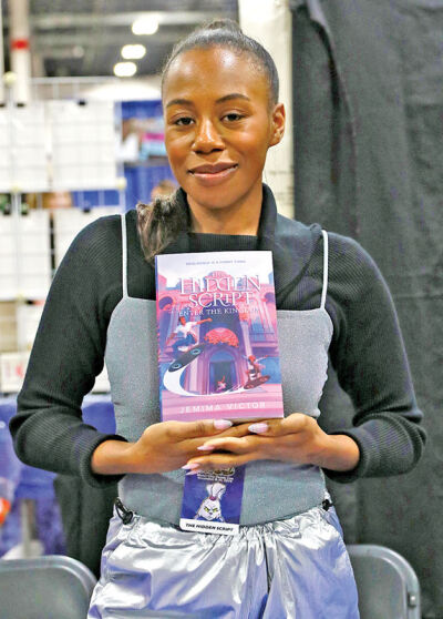  Author Jemima Victor promotes her book, “The Hidden Script: Enter the Kingdom” at last year’s fall Motor City Comic Con. 