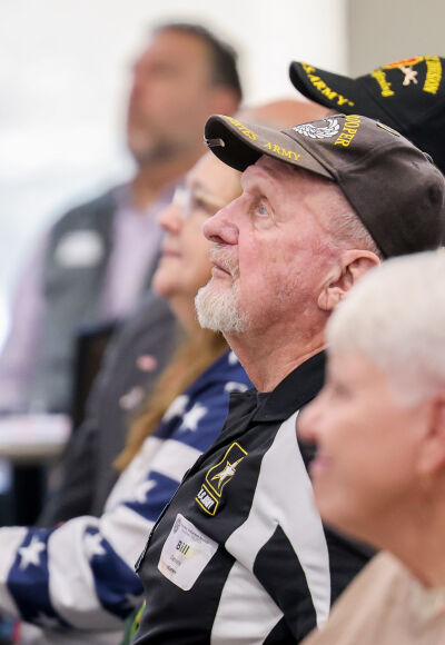  On Nov. 10, U.S. Army veteran Bill Daniels watches the video of past Honorary Veterans Day brunches held at Roseville High School. 