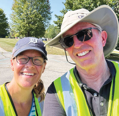  Councilman Brian Smith, right, poses for a picture with Karla Halvangis during an adopt-a-road cleanup event in Novi. 