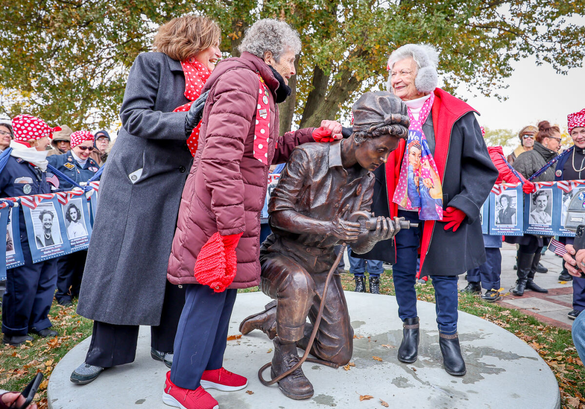  Mauro Masters and her fellow Rosie, Delphine Klaput, unveil the Rosie the Riveter statue for its dedication.  