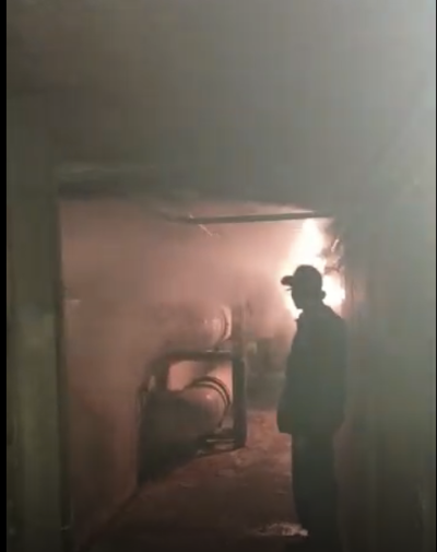  A screenshot of a video the university facilities team took shows steam filling an underground tunnel that houses a failing high temperature hot water pipe system that services multiple buildings across campus. 