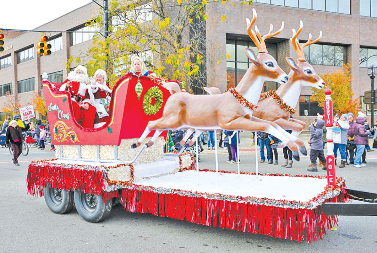  Santa and Mrs. Claus wave to Mount Clemens Santa Parade attendees at a recent parade.  