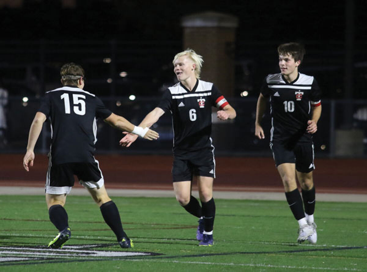  Troy seniors Carter Cusmano (right), Nick Worrell (center), and Zach Penoza (left) celebrate a goal in Troy’s 4-0 win over Melvindale Sept. 22. at Troy High School.  