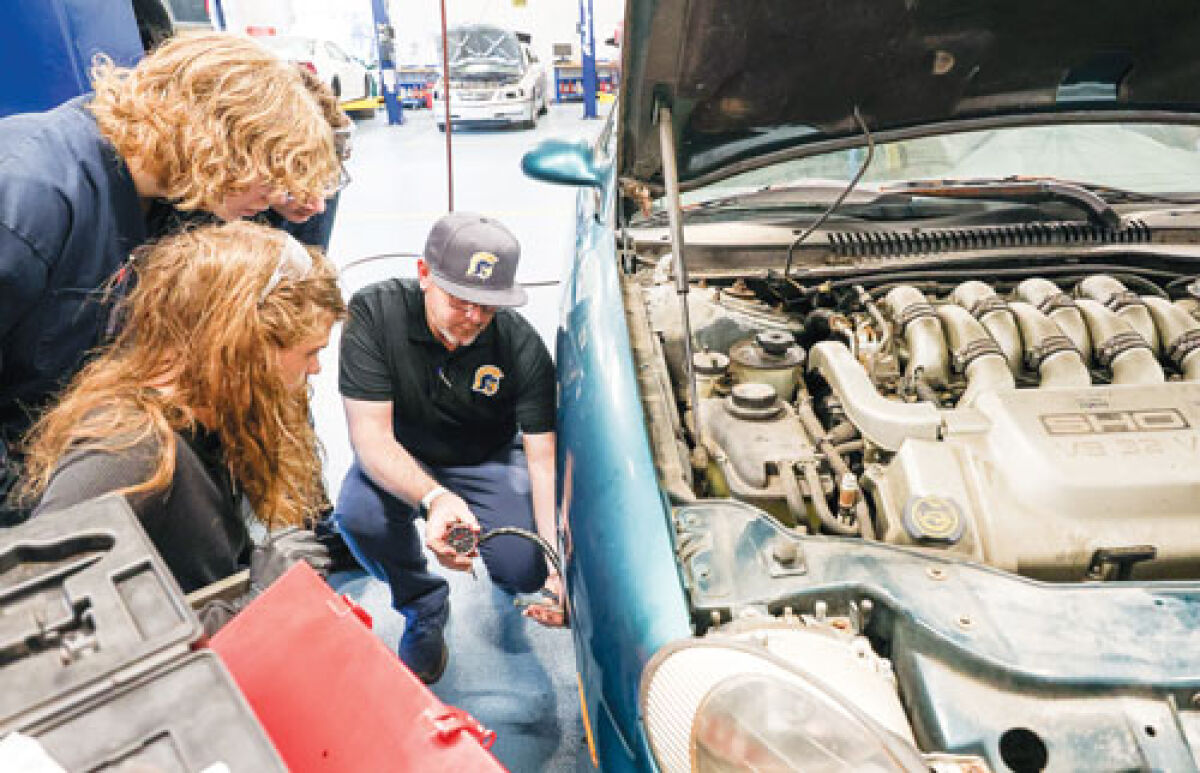  Fitzgerald High School auto teacher Richie Sackett instructs students on using a dial indicator to measure brake rotor run out during a lesson Nov. 19.  The auto technology program is part of the Southwest Macomb Technical Education Consortium SMTEC, which welcomes students from Fitzgerald, Warren Woods Tower, Lincoln and Center Line high schools.  