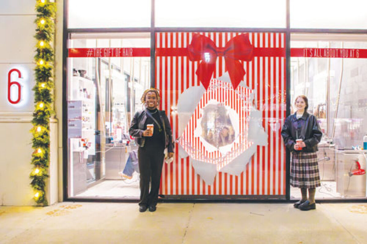  College for Creative Studies students Miracle Hubbard Wray, of Detroit, left, and Brandi Witek, right, of Warren created a window display for the Detroit retailer 6 Salon as part of the “Windows on Woodward” project with Bedrock. Witek is a 2020 Cousino High School graduate. 